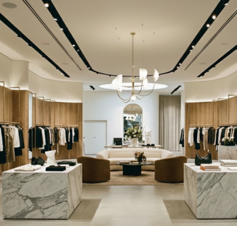Modern luxury clothing store interior with racks and marble displays